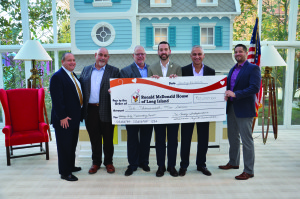 Matthew Campo (center) holding a symbolic check with (l-r) Richard Satin, RMHLI board member and Tri-County officers, Ron Brunell, James Bastian, Peter Phillips and Adam Erickson.