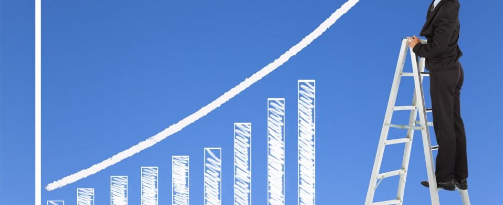 business man writing growth bar chart with sky background